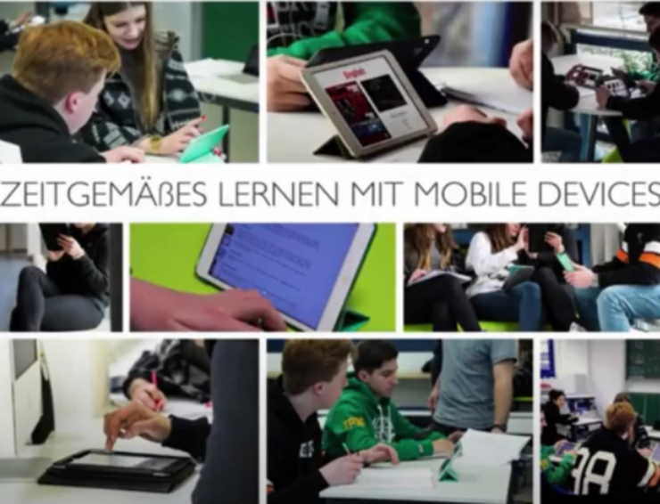Bild zeigt Schülerinnen und Schüler die mit IPADs arbeiten